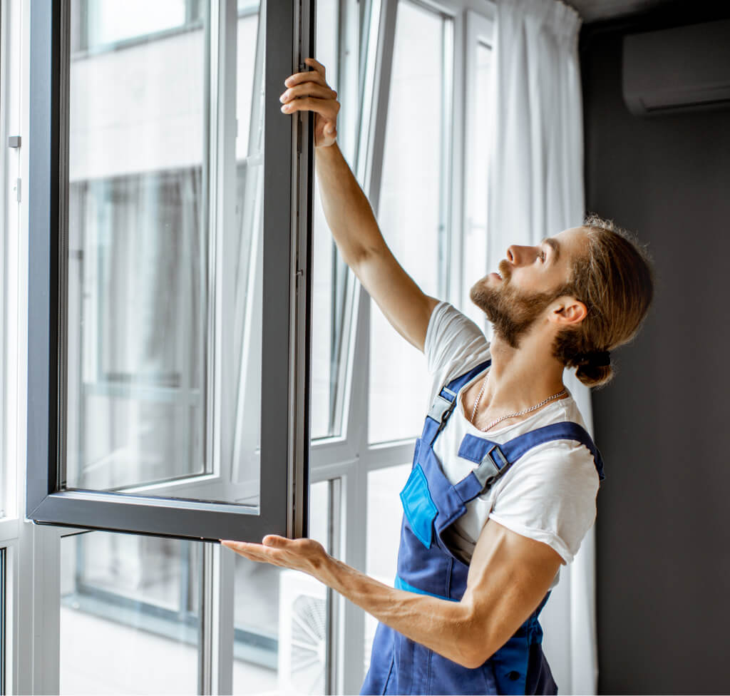 workman-adjusting-window-frames-at-home